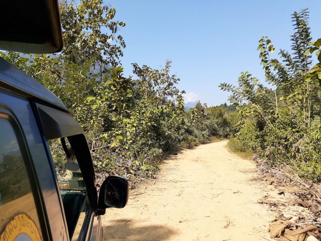 A bumpy road with dust swirling in the air