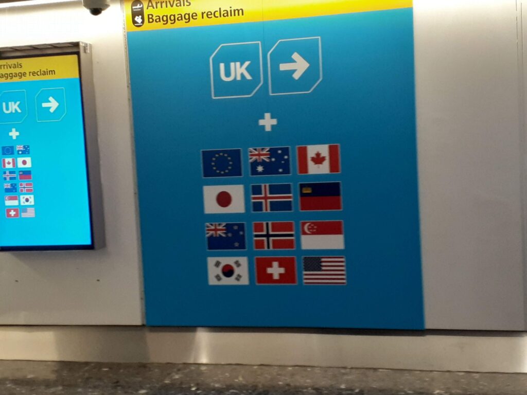 Sign of which way to go for the immigration of UK, following the country flag