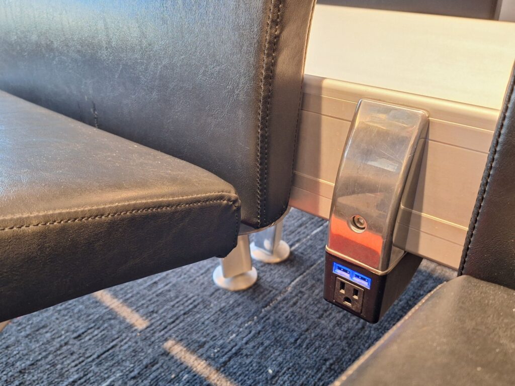 Power socket by the chairs in Montreal international airport 