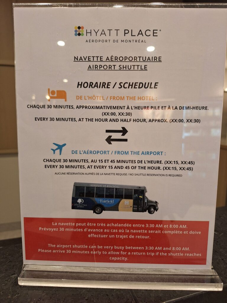 Information about the airport shuttle bus of Hyatt place Montreal airport at the front desk of the hotel