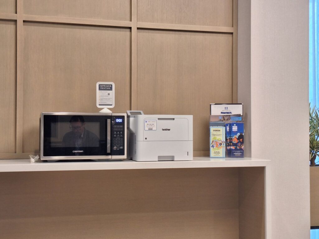 A microwave and a printer by the reception of Hyatt place Montreal airport