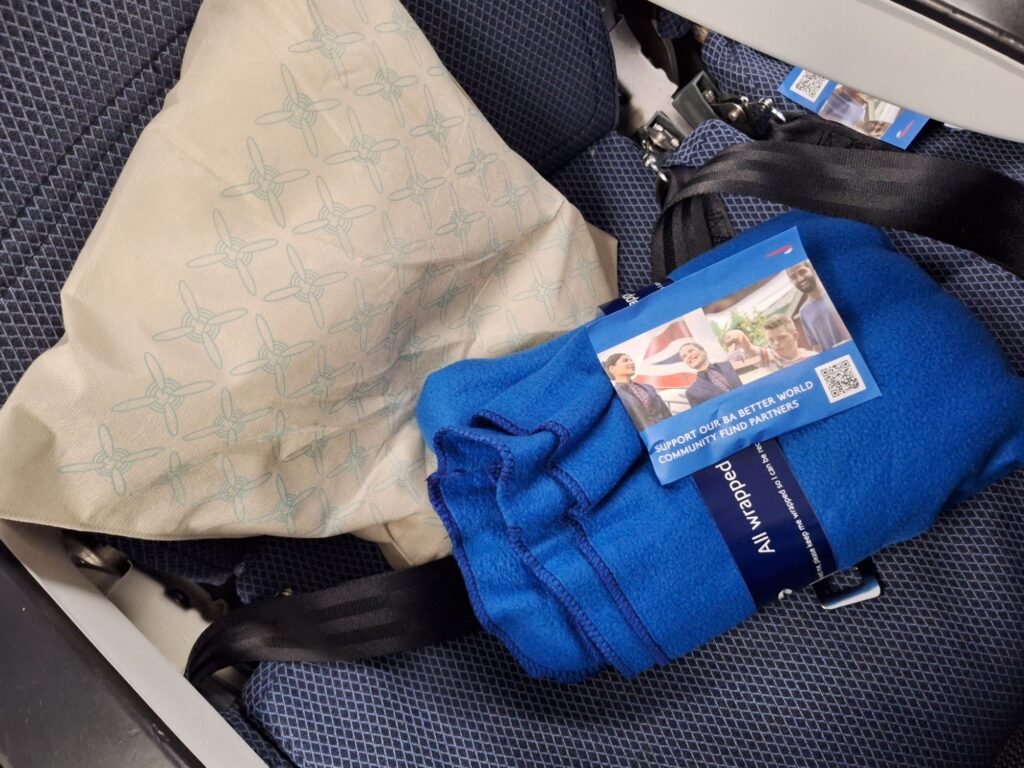 A pillow, a bracket and headset of British airways 