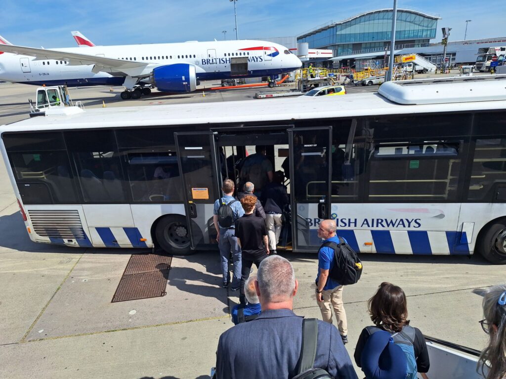 Desembarking and taking a bus to get to the airport terminal building at Heathrow airport 