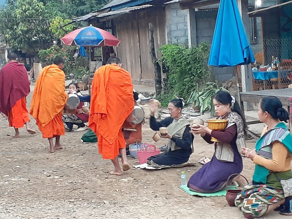 Monks and people in Muang Ngoi, Laos 