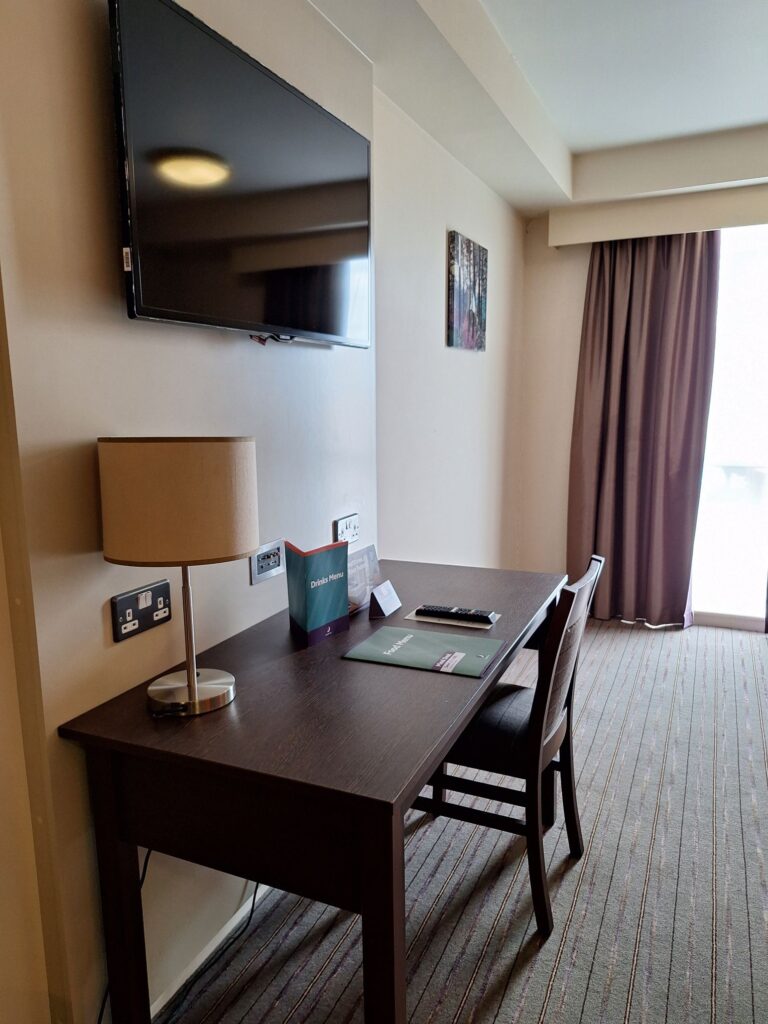 The desk and TV in the room of Premier Inn Cambridge East (Newmarket Road)