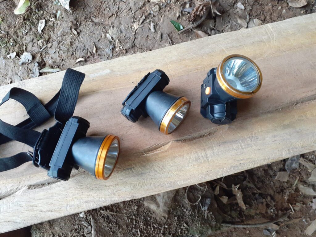 A headlamp placed at the entrance to the cave