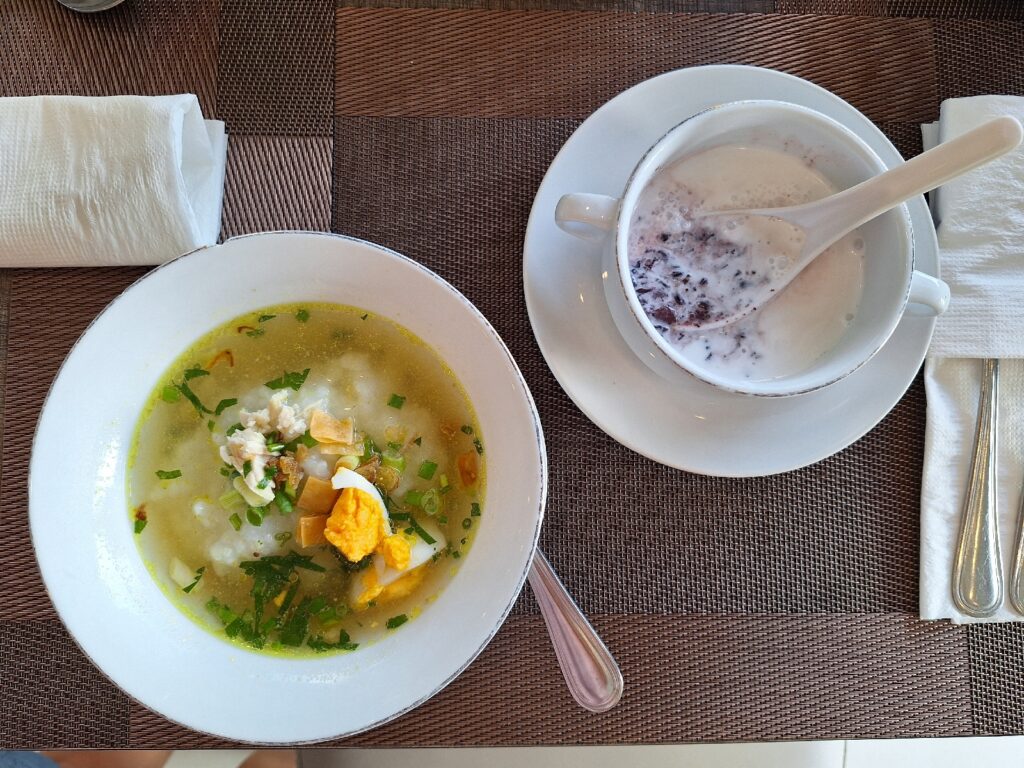 Chicken-based porridge and black sticky rice coconut milk in Vega Hotel Sorong