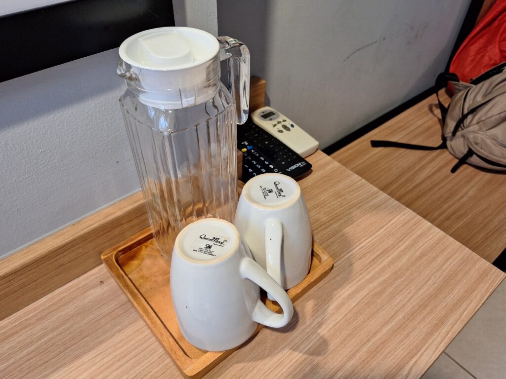 Cups and a bottle in our room in Studio One Thamrin Hotel