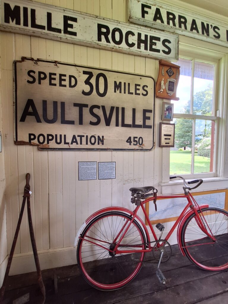 Inside the station, where historic village entrance signs are preserved.